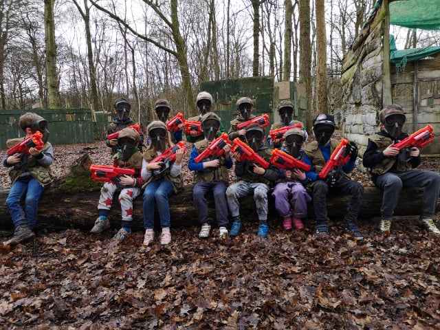 A group of children are playing with Nerf toy guns